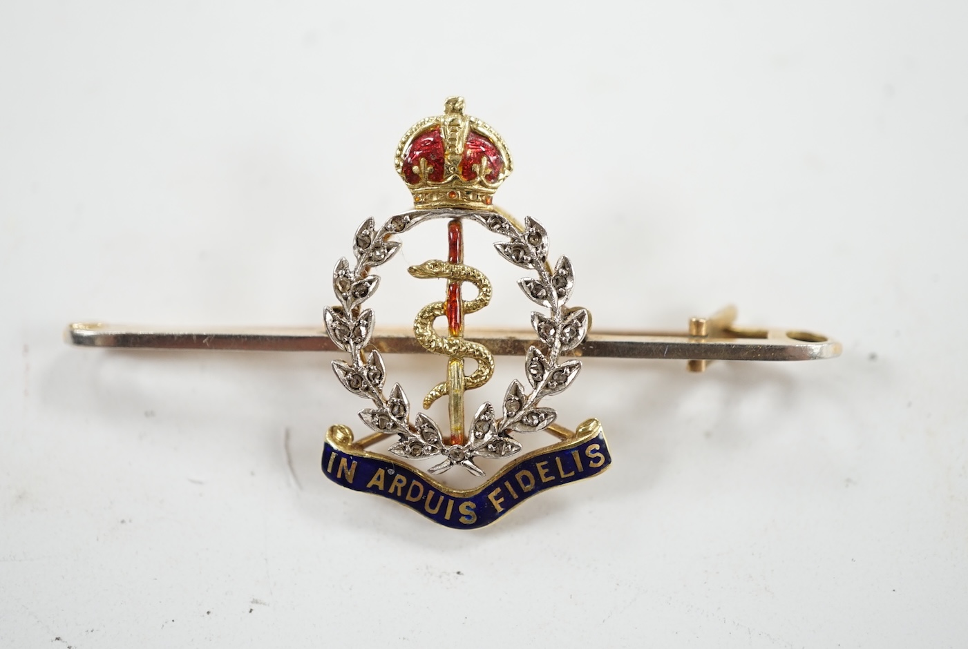 A mid 20th century 15ct, enamel and diamond set Royal Army Medical Corps sweethearts brooch, 49mm, gross weight 5 grams, in a Garrard & Co box. Condition - good